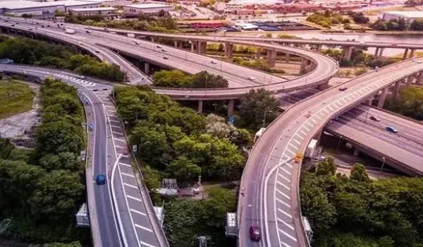Aerial view of a multi-level expressway interchange with sweeping ramps