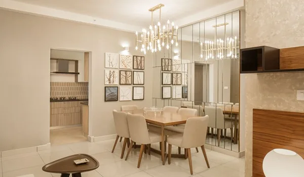 Dining table and chairs set beside a window in an apartment interior