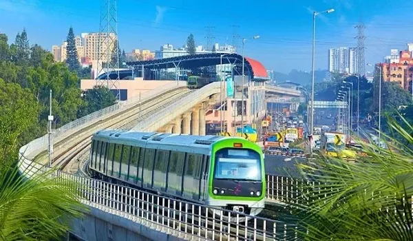 Namma Metro train on an elevated viaduct above a busy Bengaluru road